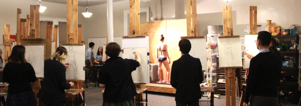 Art class drawing a partially nude model