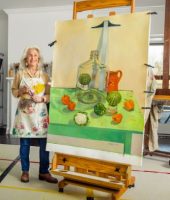 Photo of Penelope Harris next to Her artwork on an easel